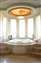 This dramatic dome supports a pendant light, crowning the tub's rotunda